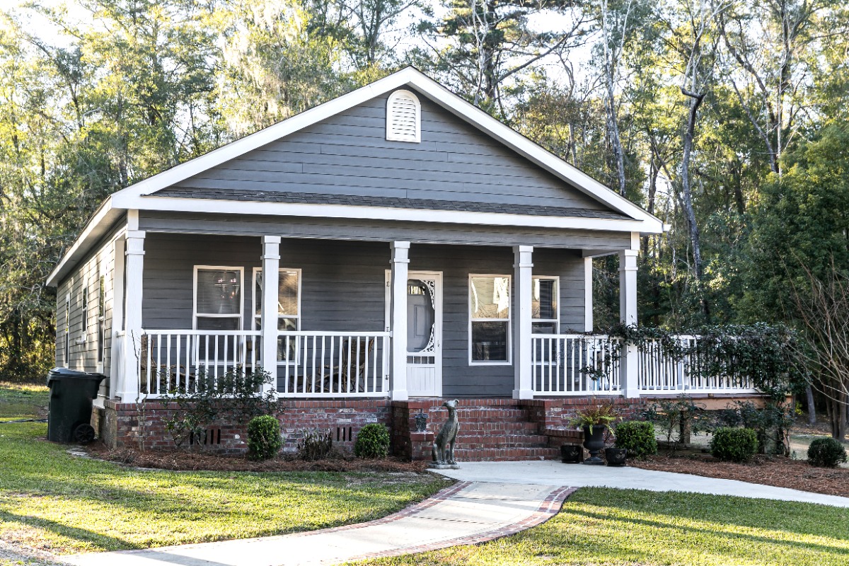 small blue gray mobile home with a blue siding