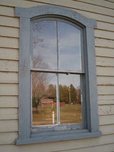 window and old worn out siding