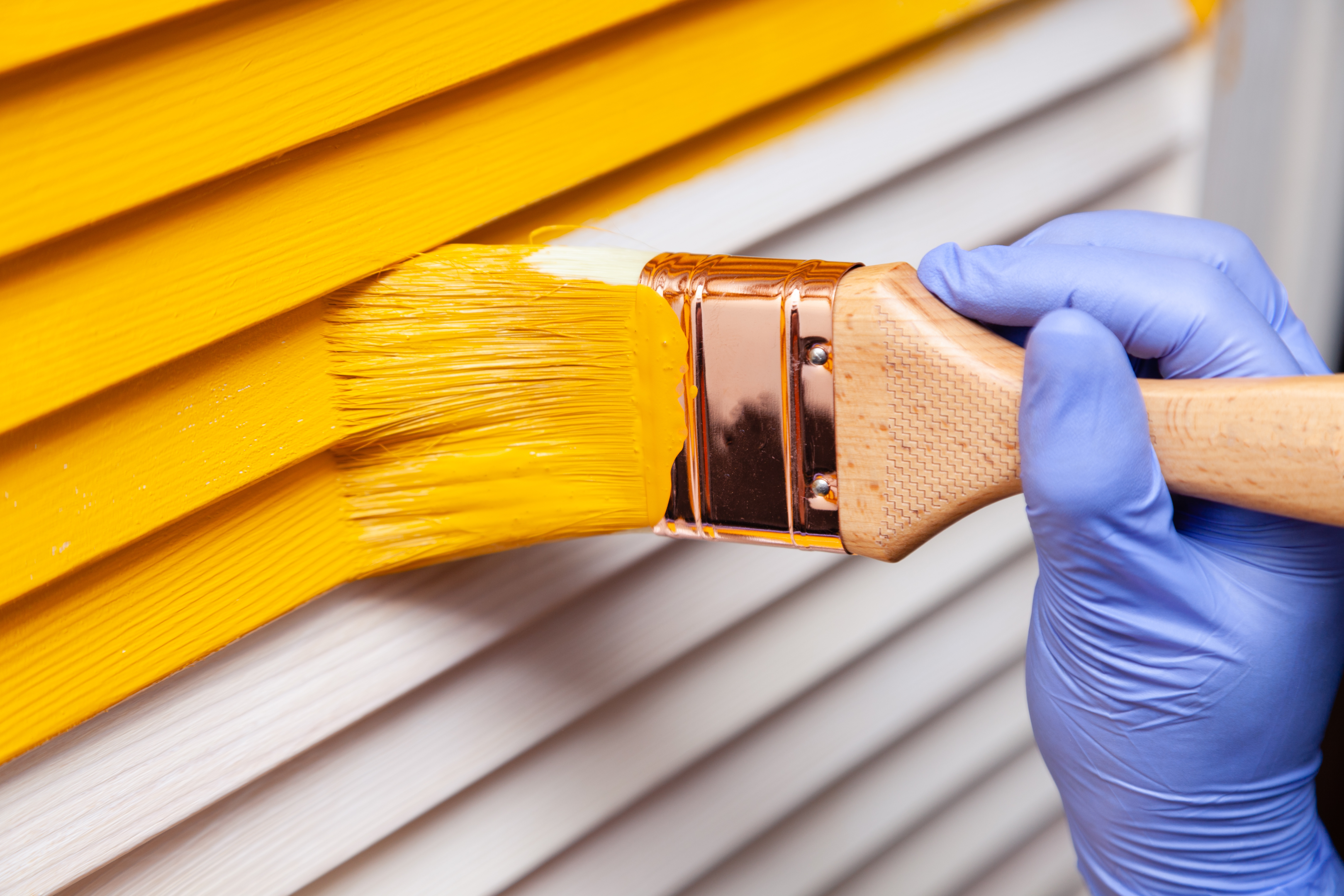 A person inspecting Hardie Board siding