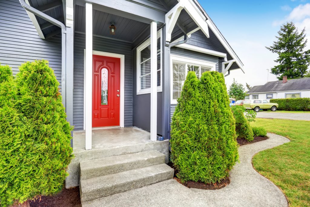 classic american house with siding trim and red entry door