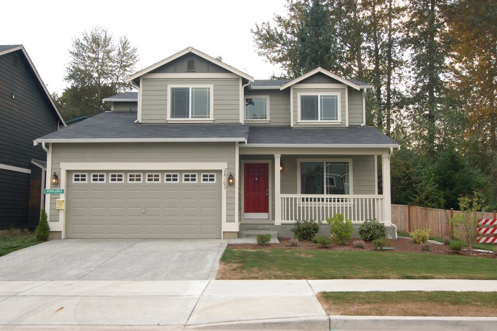 siding house exterior with pine trees on background