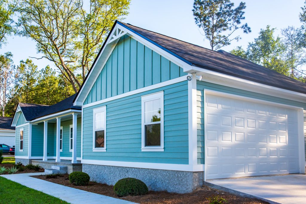 Ballard Seattle Front view of a brand new construction house with blue siding, a ranch style home with a yard